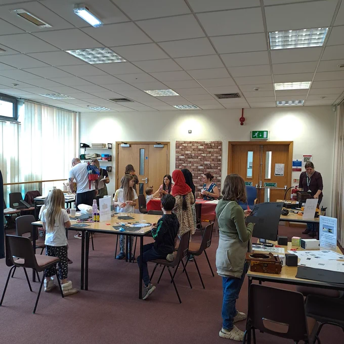 A room of people getting involved in craft activities 
