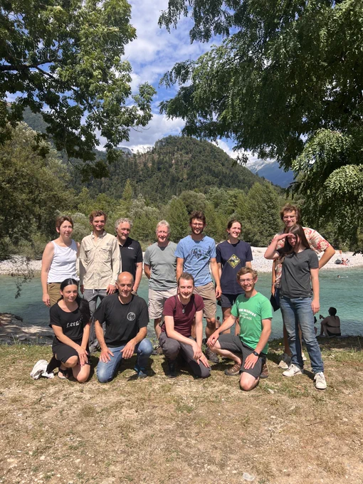 A group photo of the members of Imperial College and Tolmin caving clubs, together with DHM Helen Teasdale. In the background we can see the ‘hollow mountain’ and beautiful turquoise Soča river, basking in the sun.
