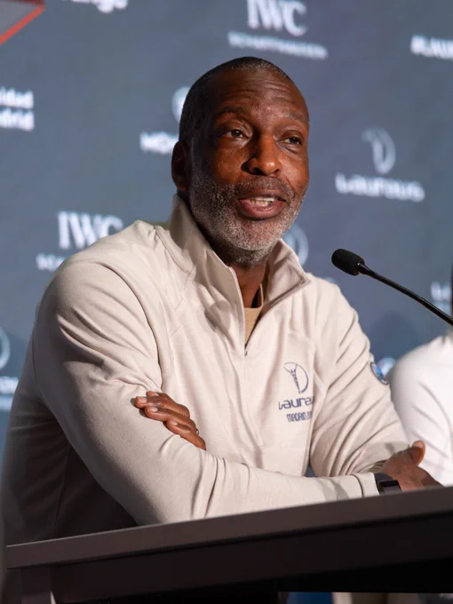 Stroke survivor Michael Johnson is speaking with a microphone on stage at an event