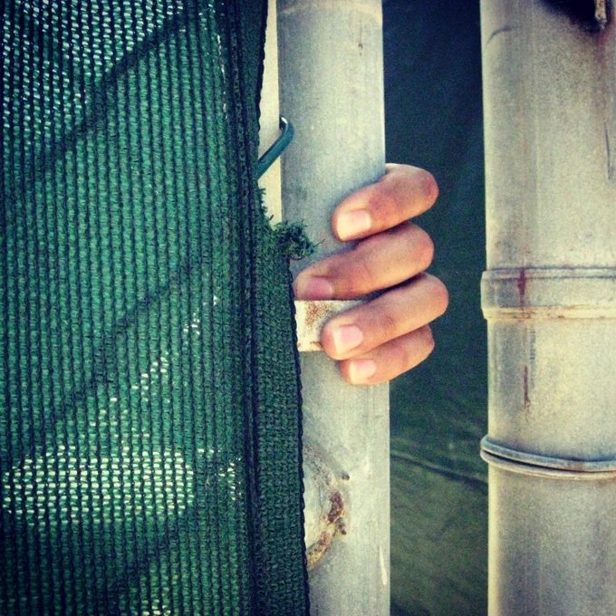 A guard holds a gate shut at Camp Echo inside the secretive prison zone at Guantanamo Bay. (file photo)