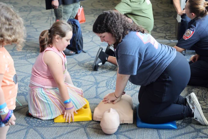 woman and girl doing CPR on a dummy