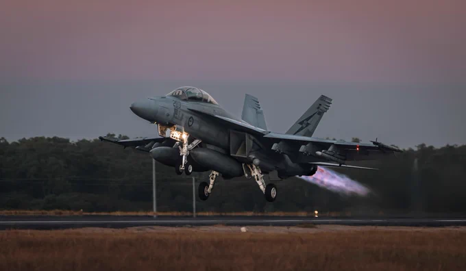 Royal Australian Air Force F-18 taking off at sunset.