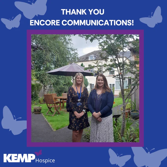 Image of two women stood smiling in a garden with text saying thank you to Encore communications above the image. There are also blue butterflies around the boarder of the image 