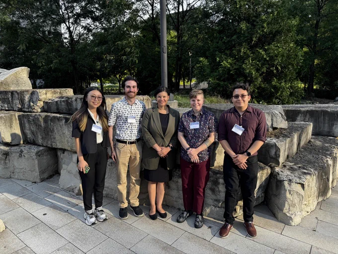 Image of CHARM participants posing for a group picture outdoors on a patio. Participants are dressed in business casual attire.

From left to right: Ruiqi Hu, Kenny Crane-Moscowitz, Dr. LaShanda Korley, Allie Landry, and Wilder Acuna Gonzalez.