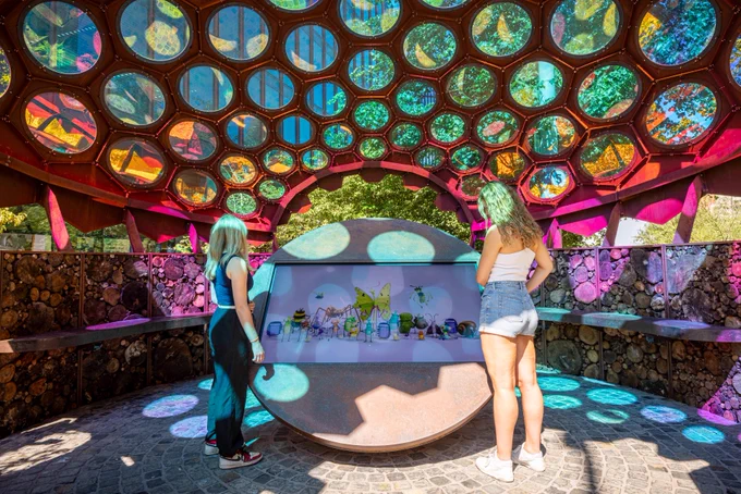 People visiting the iridescent dome of the RES Garden at Stratford Cross