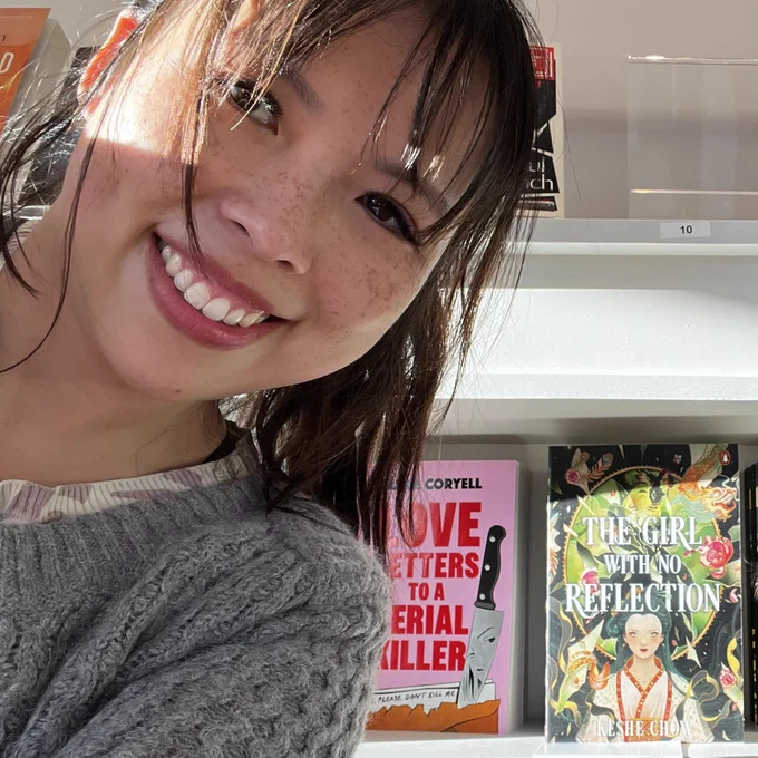 A selfie of me in front of my book in a bookshop