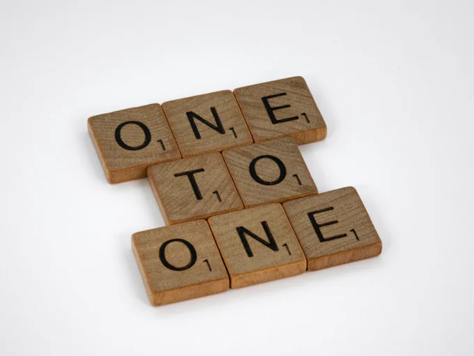 Scrabble tiles spelling out "one to one"
