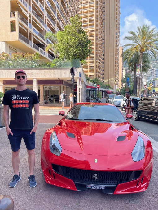 Callum standing next to a Ferrari car in Monaco.