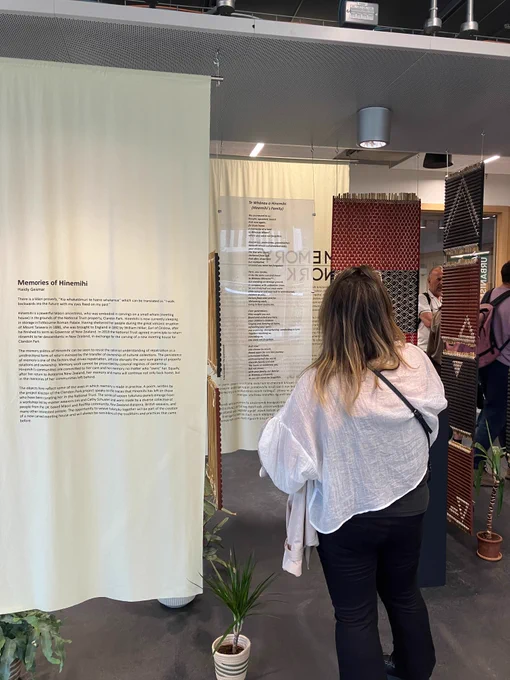 Visitor at the 'Memories of Hinemihi' exhibit which includes Māori woven panels