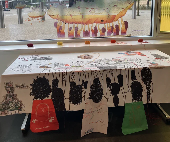 'Living archives' exhibit showing illustrations of women holding up community