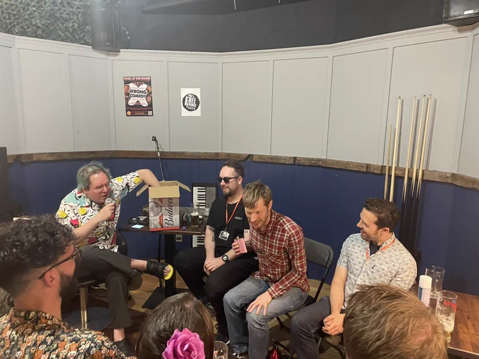 Three guests and Friz the host delving into a cardboard box