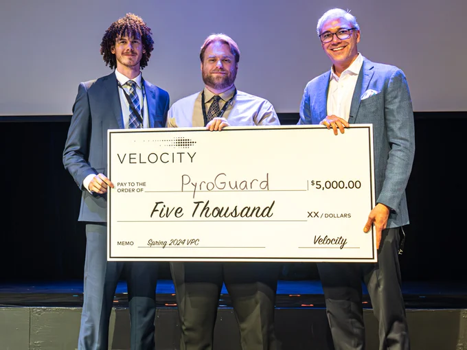 PyroGuard team Kade Truman and Drew Davidson accept grant from John Dick, director, Velocity Campus