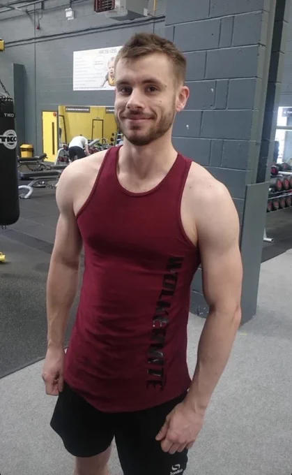 Callum looking into the camera at the gym with his vest on as he got ready to workout.