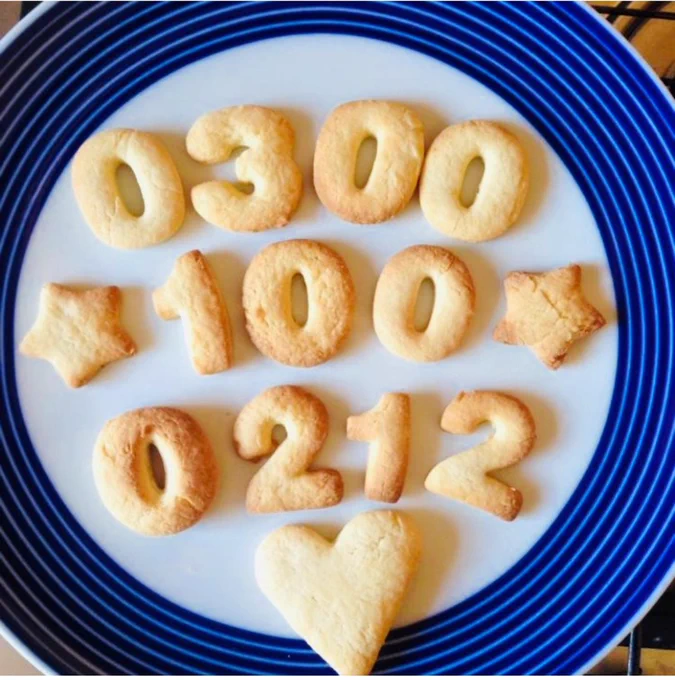 0300 100 0212 spelled out in biscuits on a plate.