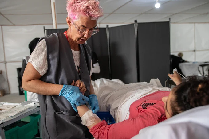 Becky Platt, the Emergency Health Unit's paediatric nurse taking care of an injured girl in Gaza