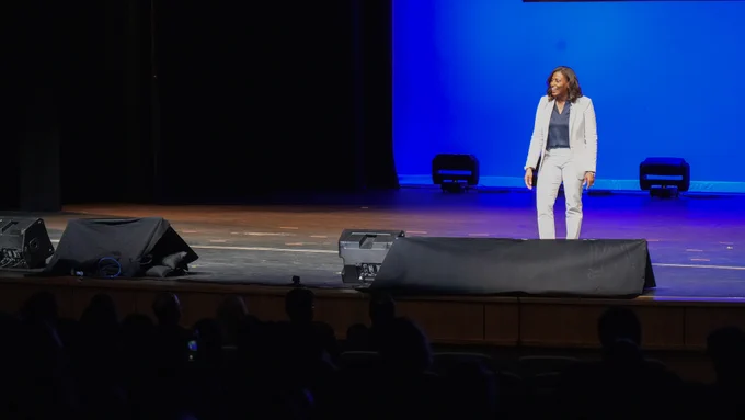 Dr. McDade on stage speaking to the audience.