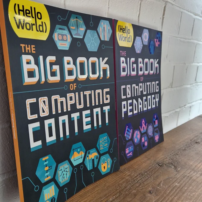 Image taken at angle of the Big Book of Computing Content and The Big Book of Computing pedagogy displayed on shelf.