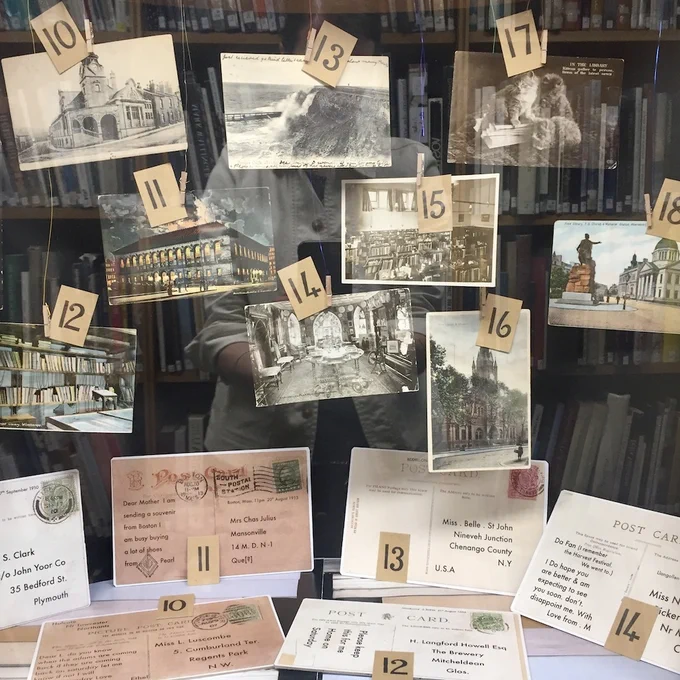 A photo of several postcards from the RCA Library mezzanine display.