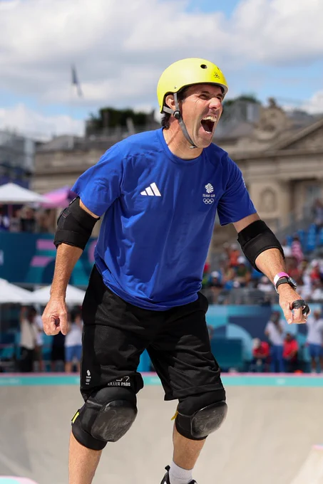Andy Macdonald smiling joyfully in his skating attire after completing his run at Paris 2024. 