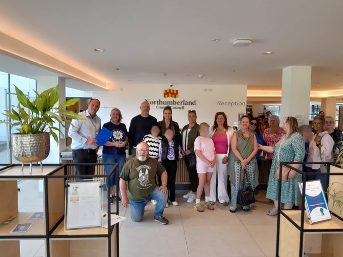 A group of diverse foster carers delivering their petition at the Council offices in Northumberland. 