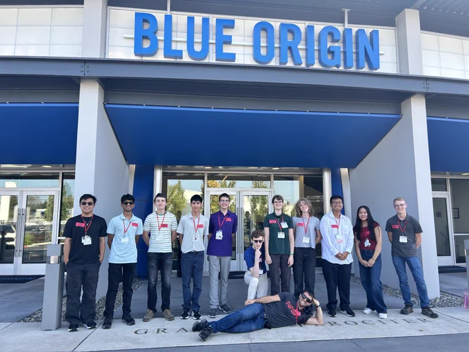 Group of scholars in the front of blue origin