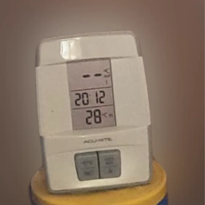 Photo of a digital thermomer showing a temperature of 28 degrees Celsius