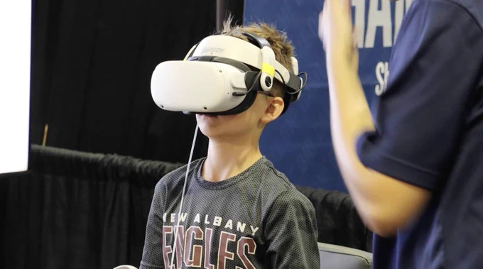 A child wearing a Virtual Reality headset in our Universe of Opportunity exhibit.