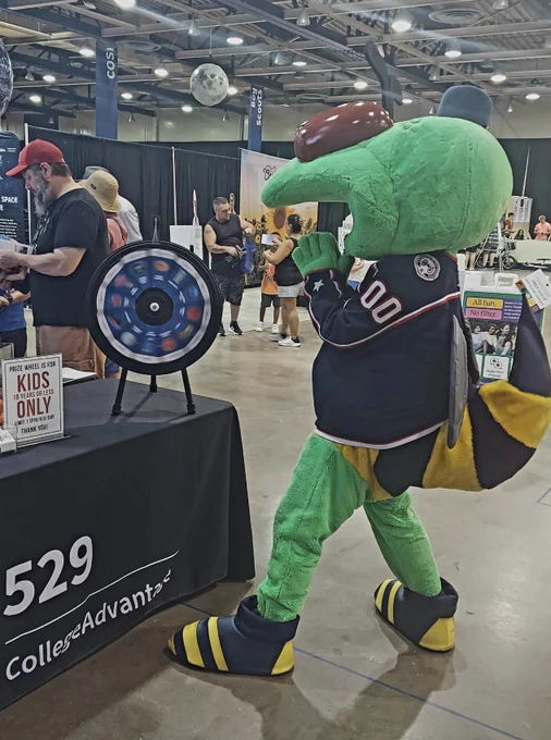 A mascot spinning the prize wheel.