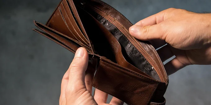 Someone opening their wallet and it's empty
