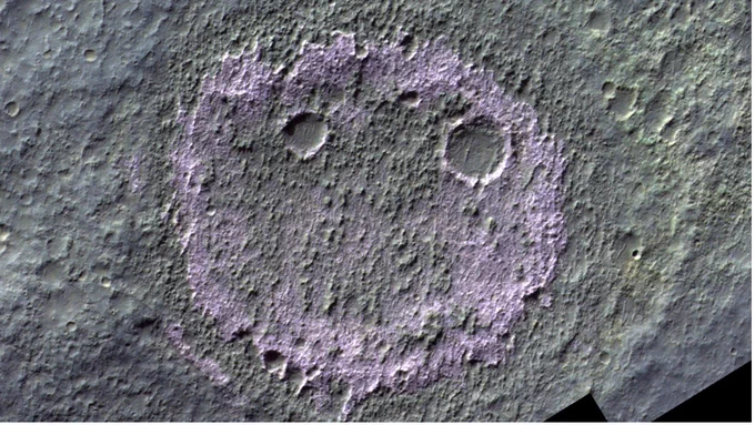 Chloride-bearing terrain on Mars does not stand out in regular black-and-white images but shows up a distinct pink to purple hue in colour-infrared images, making ESA's ExoMars CaSSIS instrument a unique tool to study the distribution of salts across Mars from orbit. In the absence of colour, chlorides are easily confused with other light-toned materials such as clays. This image shows a salt deposit in a crater with the appearance of a 'smiley'.