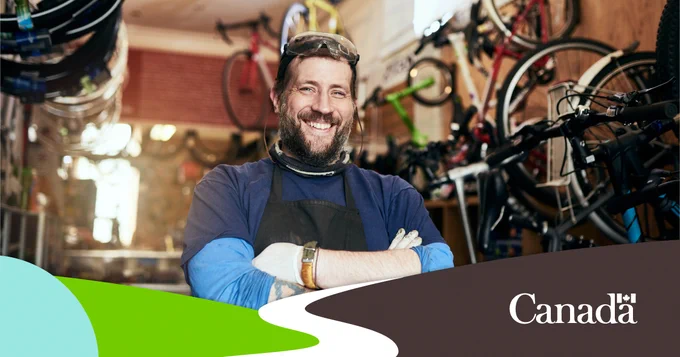 Bike repair shop owner in his bicycle workshop.  