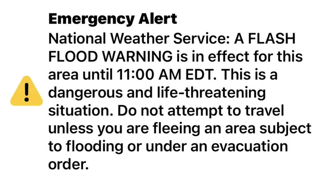 A graphic reading: National Weather Service: A FLASH FLOOD WARNING is in effect for the area until 11:00AM EDT. This is a dangerous and life-threatening situation. Do not attempt to travel unless you are fleeing an area subject to flooding or under an evacuation order.