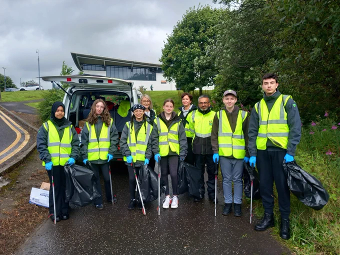 Police Scotland youth volunteers pictured outside at a litter picking event. 