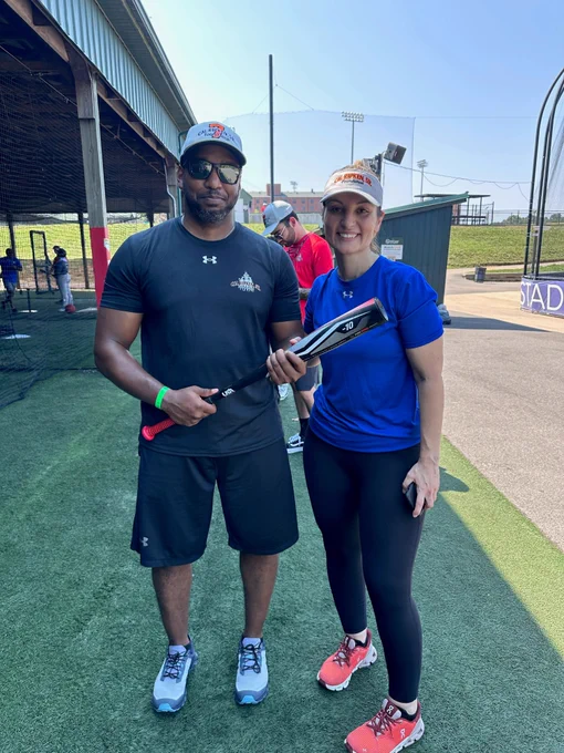 Two Deputy U.S. Marshals pose for a photo at the Badges for Baseball summer camp.