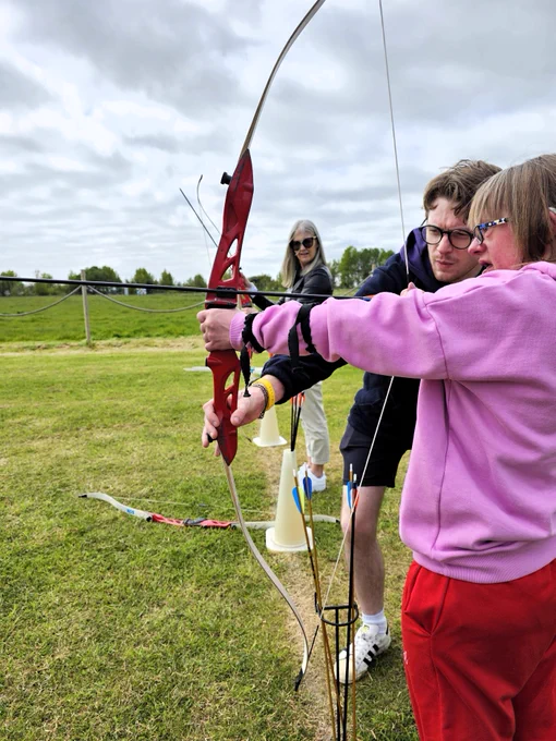 Drawing back the bow in archery, ready to aim.