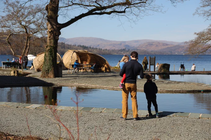 Families playing together near the Boating pond at Windermere Jetty Museum.