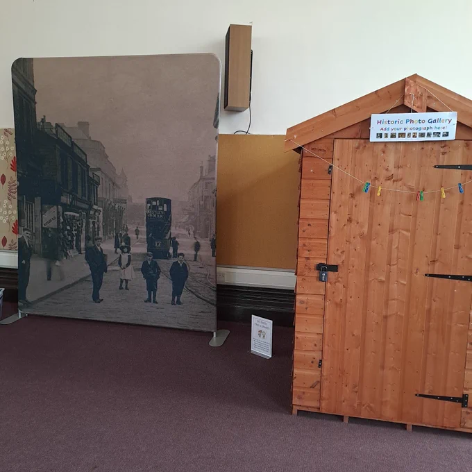 A background of Accrington from the past next to a shed with a sign that says Historic Photo Gallery 