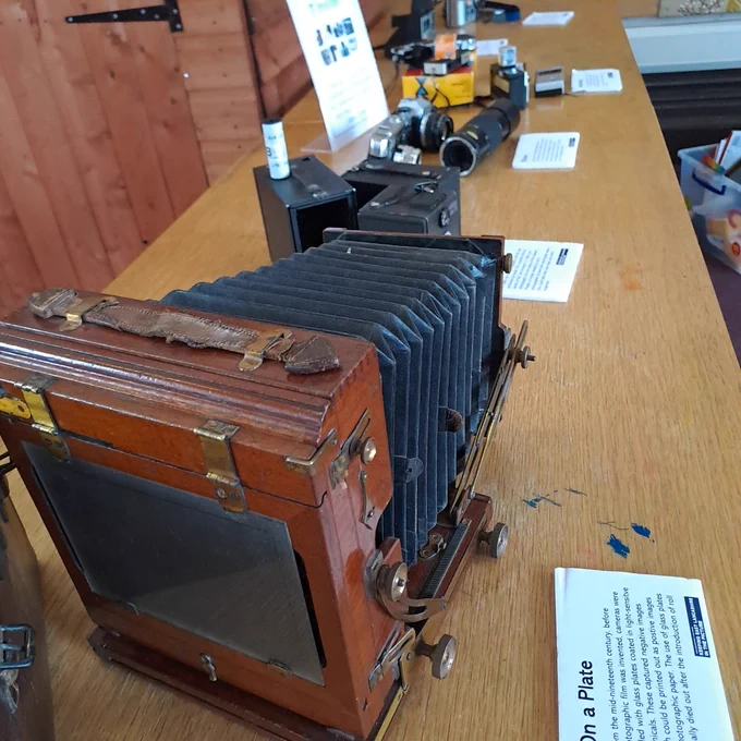 Old cameras laid out on a table 