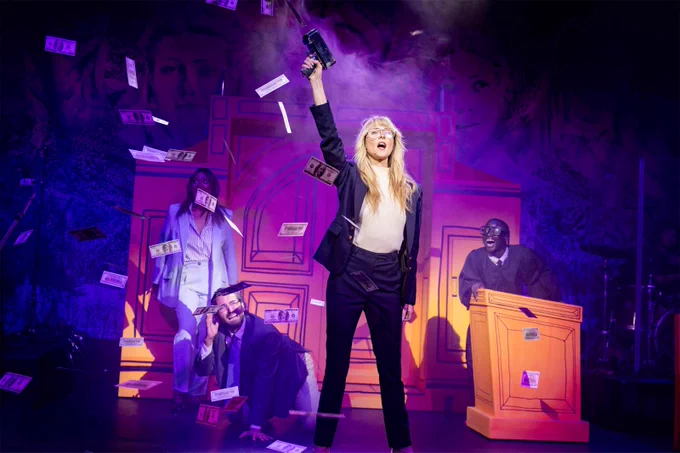 Diana Vickers in the title role shoots money in the air