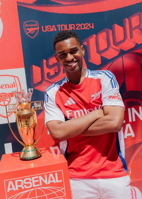 Amir posing with the gold Premier League trophy in the USA.