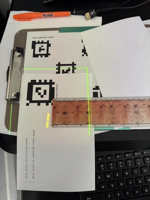 A ruler measuring an AprilTag's distance from the page