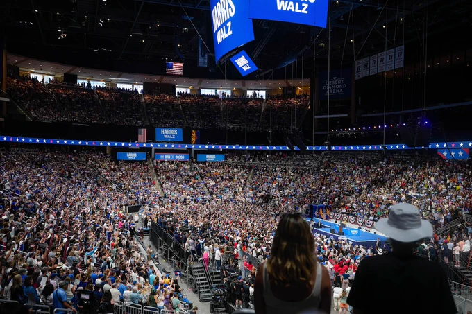 A zoomed out shot of an arena full of Harris-Walz supporters. 