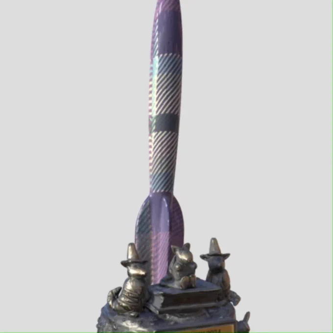 A rocket patterned in the Glasgow2024 tartan. Sitting on the metal base are three armadillos, two with wizard hats. The award reads "GLASGOW 2024, HAPPY APRIL FOOL'S DAY, 1st APRIL 2024"