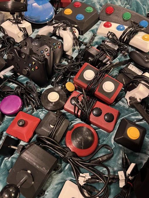 Pictured are dozens of buttons and switches designed to play video games considering accessibility barriers. The buttons and switches are all different colors.