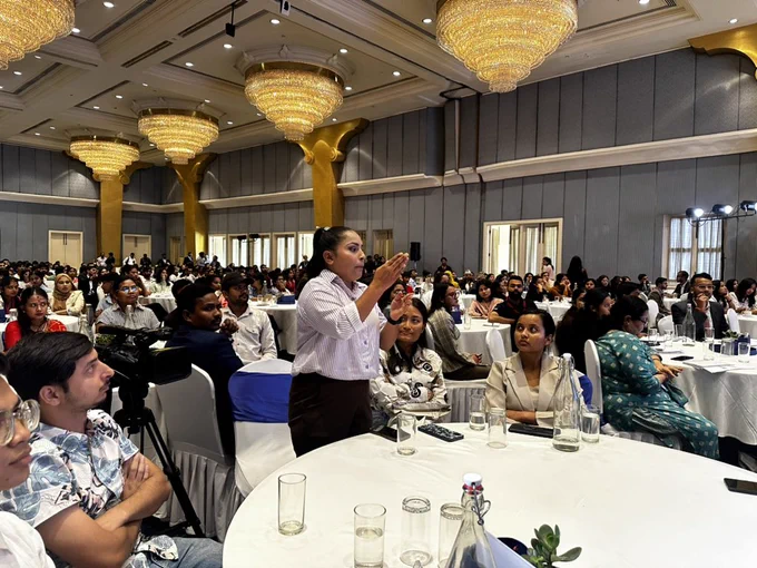 Image of a youth participation asking a question in sign language