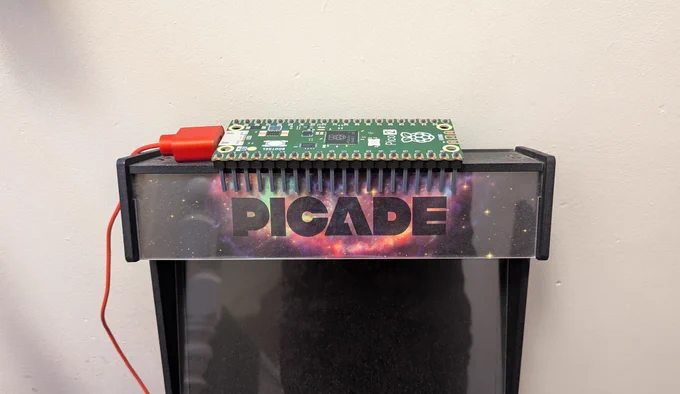 A massive Raspberry Pi Pico 2 sitting on top of an arcade cabinet