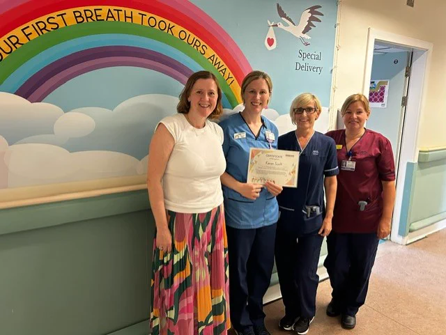 Karen Scott being presented by the members of the Labour Ward team