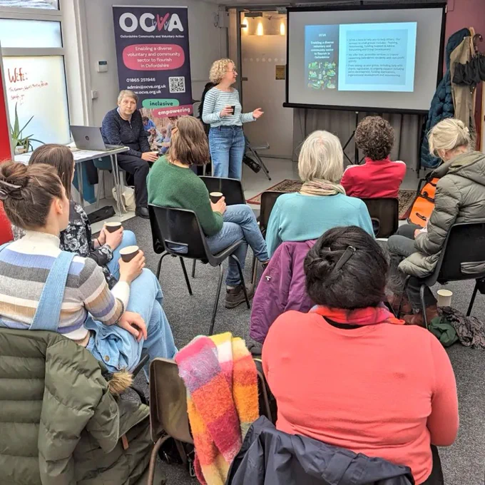 Training session with projector and slides. Person presents at the front. ocva banner in the background.