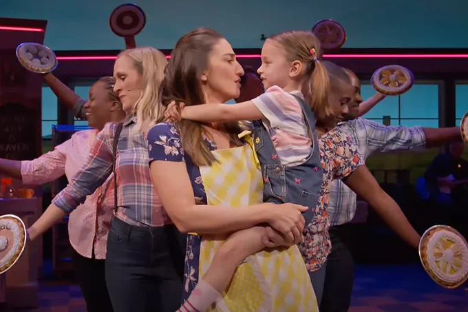 A photo showing a group of people dancing while holding pies 