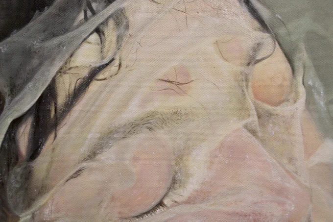 A close-up of the painting showing part of the artist's face.